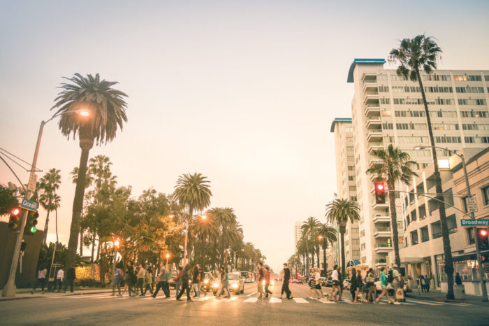 Locals and tourists walking on zebra crossing and on Ocean Ave i