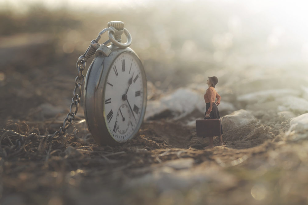 little woman looks amazed at the big clock