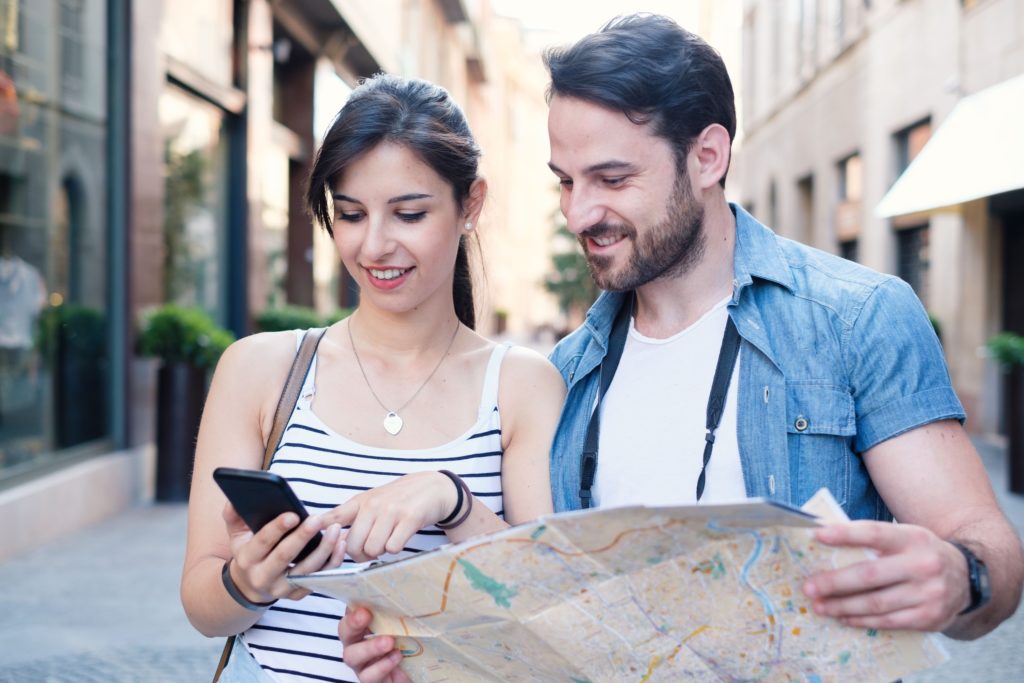 travel map phone couple looking for flights